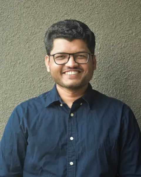 Vinay Kadam smiling in a navy shirt